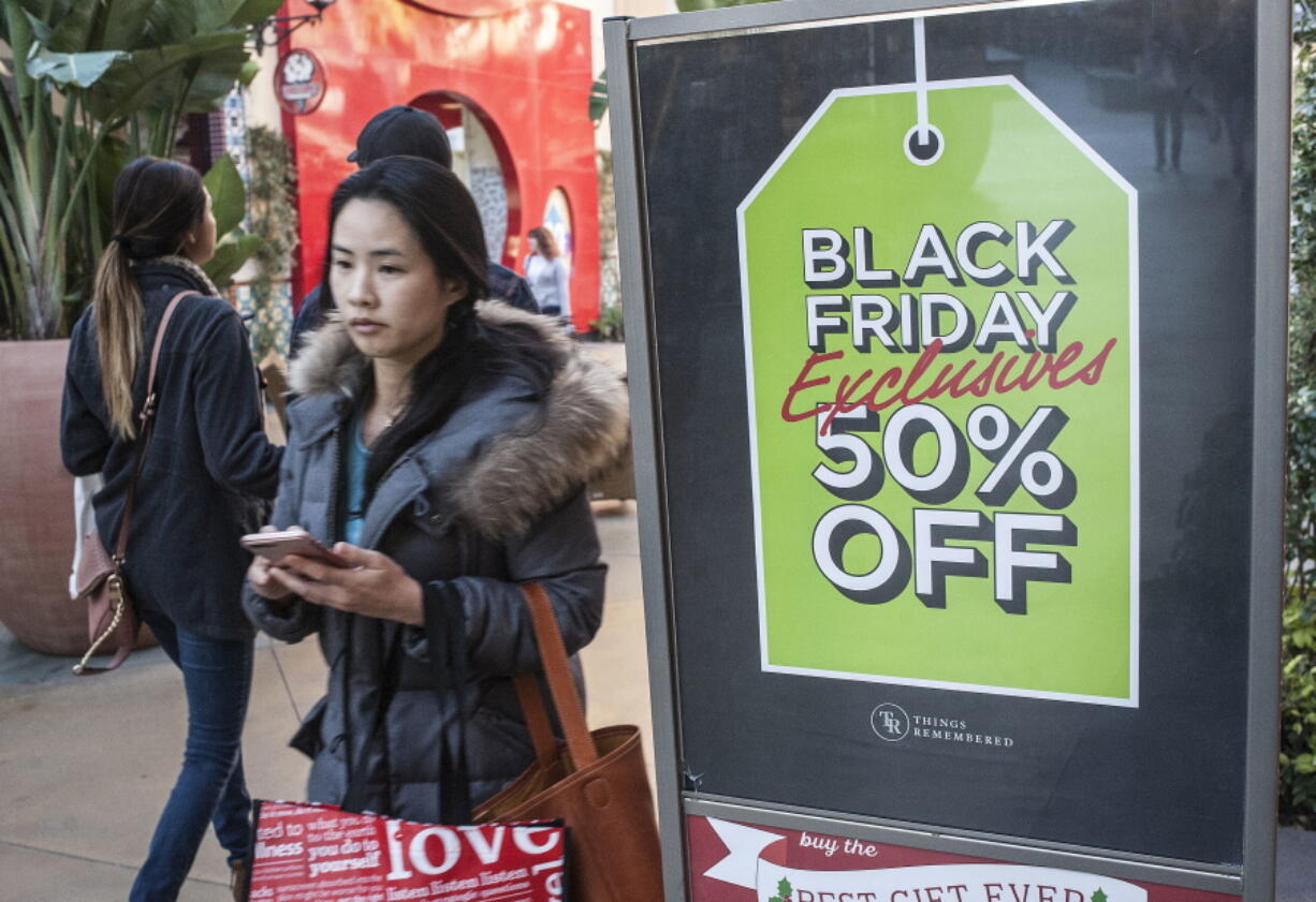 Shoppers look for deals at the Irvine Spectrum Center in Irvine, Calif., on Black Friday, Nov. 25. Stores are trying to better cater to savvier shoppers, who are splitting their spending back and forth online and in stores.