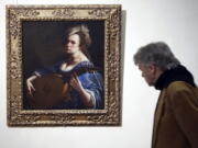 A visitor admires &quot;Self-Portrait as a Lute Player&quot; by 17th-century Italian artist Artemisia Gentileschi, on display at Rome&#039;s Braschi Palace museum, Tuesday. The Braschi museum is hosting the exhibition &quot;Artemisia Gentileschi and her Times&quot; from Nov. 30 to May 7.