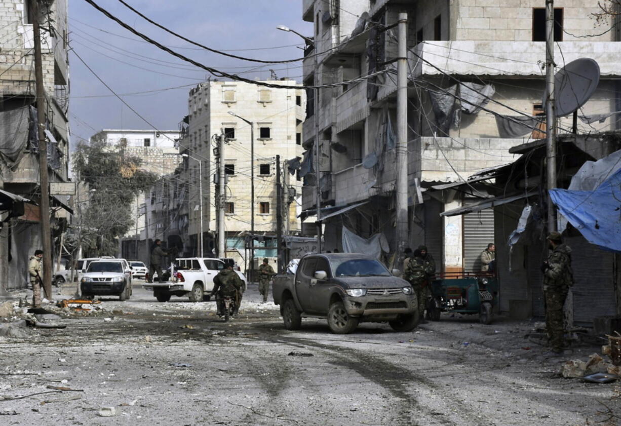 Syrian troops march through the streets of east Aleppo, Syria, on Monday. Syria&#039;s military said Monday it has regained control of 98 percent of eastern Aleppo, as government forces close in the last remaining sliver of a rebel enclave packed with fighters as well as tens of thousands of civilians.