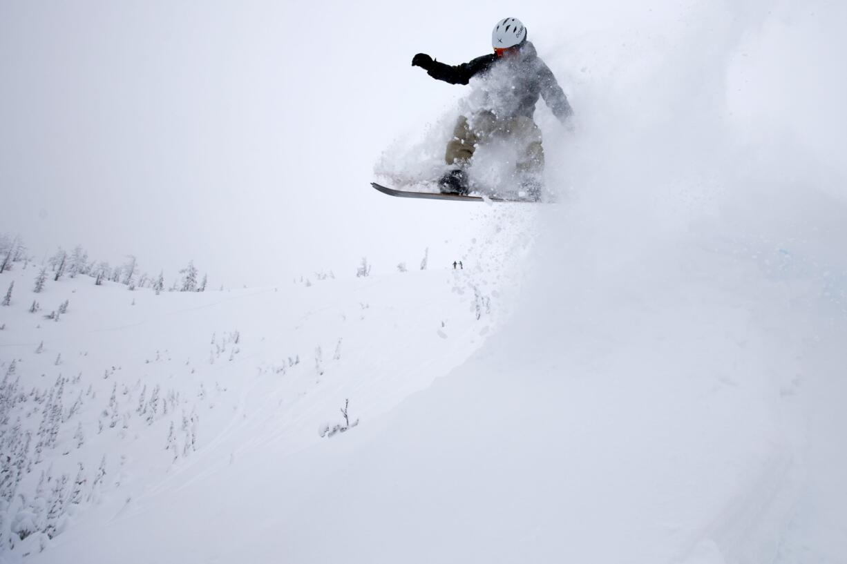 JD Platt floats off a powdery lip while riding deep snow on the Cindercone at Mount Bachelor.