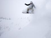 JD Platt floats off a powdery lip while riding deep snow on the Cindercone at Mount Bachelor.