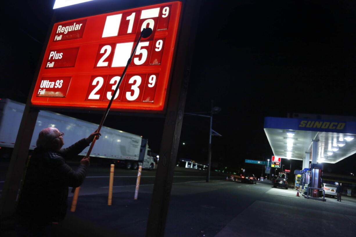 Leon Balagula changes the price for the gasoline at his Sunoco station in the early morning, in Fort Lee, N.J., on Tuesday, Nov. 1. OPEC's decision on Wednesday, Nov. 30, 2016, to cut production gave an immediate boost to oil prices, but the impact on consumers is likely to be more modest and gradual.