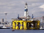 The oil drilling rig Polar Pioneer is towed toward a dock in Elliott Bay in Seattle. The rig was the first of two drilling rigs Royal Dutch Shell was outfitting for Arctic oil exploration. President Barack Obama is expected to order wide swaths of the Atlantic and Arctic oceans placed permanently off-limits for oil drilling, in an 11th-hour push for environmental protection before he leaves office.