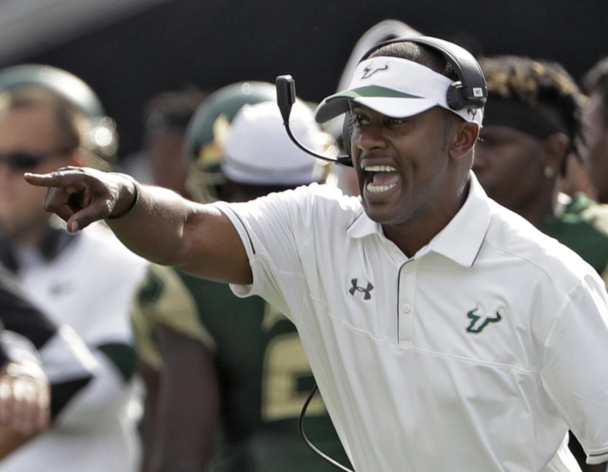 FILE - In this Nov. 26, 2016, file photo, South Florida head coach Willie Taggart shouts instructions to his team during the second half of an NCAA college football game against Central Florida, in Tampa, Fla. South Florida football coach Willie Taggart has informed the school that he is leaving to become the coach at Oregon, a person with direct knowledge of the situation tells The Associated Press. The person spoke on condition of anonymity because neither school was prepared to make an official announcement.