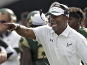 FILE - In this Nov. 26, 2016, file photo, South Florida head coach Willie Taggart shouts instructions to his team during the second half of an NCAA college football game against Central Florida, in Tampa, Fla. South Florida football coach Willie Taggart has informed the school that he is leaving to become the coach at Oregon, a person with direct knowledge of the situation tells The Associated Press. The person spoke on condition of anonymity because neither school was prepared to make an official announcement.