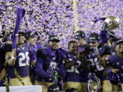 Washington players celebrate the team&#039;s 41-10 win over Colorado in the Pac-12 Conference championship NCAA college football game Friday, Dec. 2, 2016, in Santa Clara, Calif.