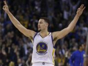 Golden State Warriors' Klay Thompson celebrates a score during the third quarter of an NBA basketball game against the Indiana Pacers Monday, Dec. 5, 2016, in Oakland, Calif.