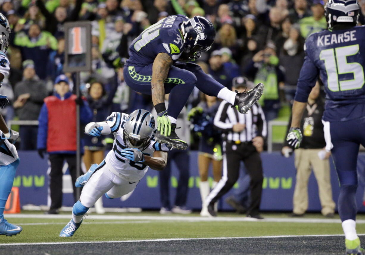 Seattle Seahawks&#039; Thomas Rawls (34) leaps over Carolina Panthers&#039; Daryl Worley to score a touchdown in the first half of an NFL football game, Sunday, Dec. 4, 2016, in Seattle. (AP Photo/Ted S.