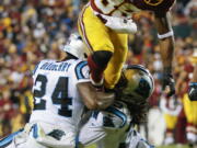 Washington wide receiver Pierre Gar?on (88) runs over the top of Carolina&#039;s James Bradberry (24) and Tre Boston.