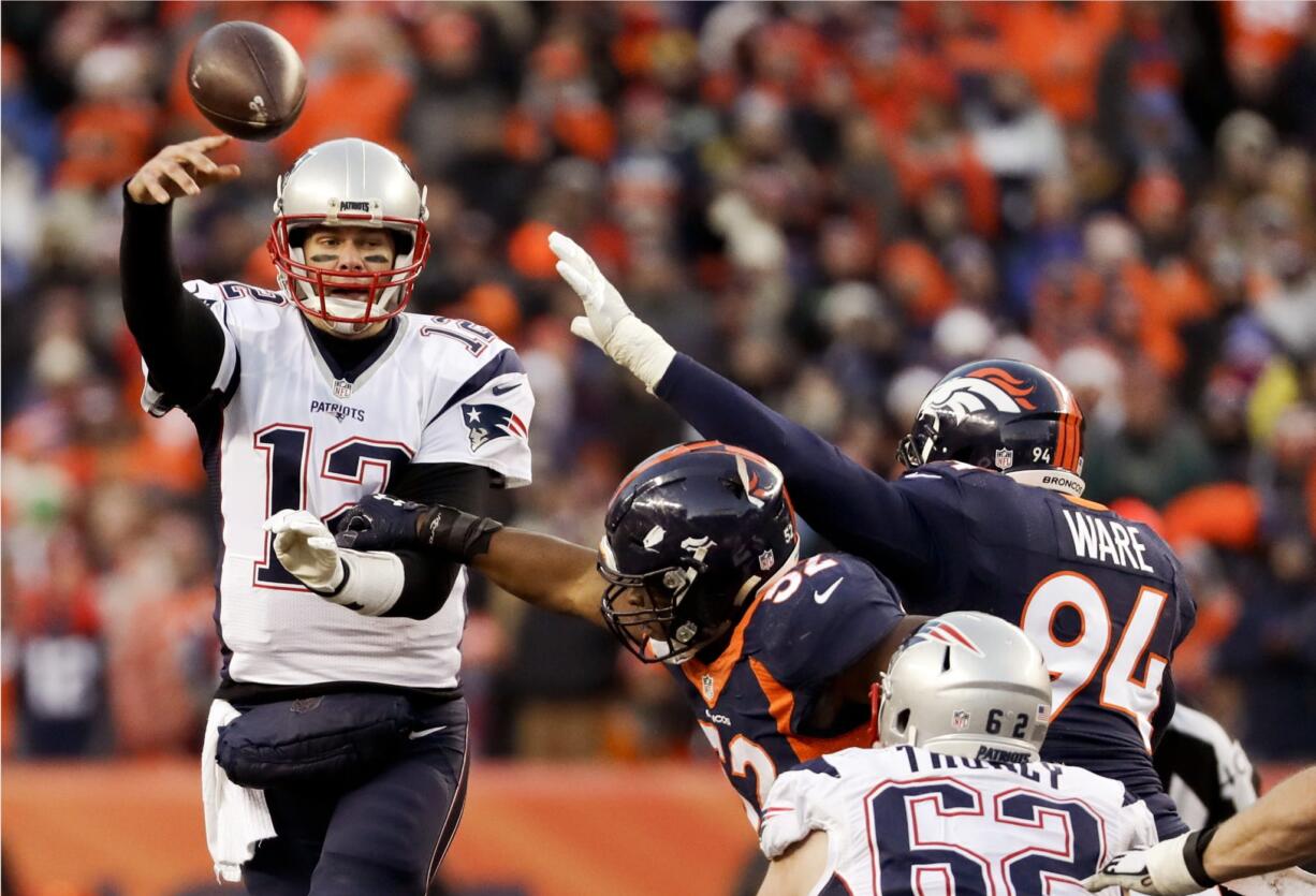 New England Patriots quarterback Tom Brady passes under pressure against the Denver Broncos during the second half of an NFL football game Sunday, Dec. 18, 2016, in Denver.