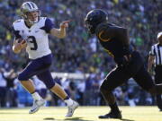 Washington quarterback Jake Browning points to Oregon&#039;s Jimmie Swain while rushing for a touchdown Oct. 8 in Eugene, Ore. It was so out of character it became the defining moment of his time at Washington.