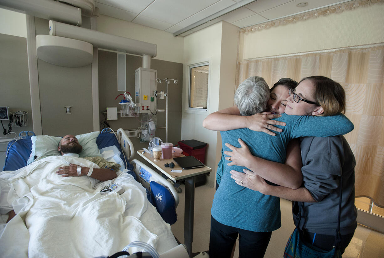 Scott Jensen of Amboy, from left, rests in his hospital bed as his mom, Therese Jensen, thanks the women who helped save his life, Hiedi Poulson of Brush Praire and Kim Detter of Battle Ground, Wednesday morning, July 6, 2016 at PeaceHealth Southwest Medical Center.