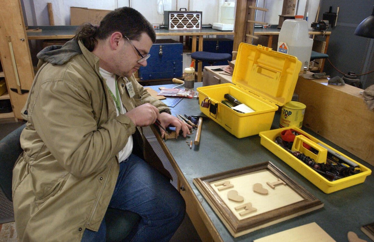 Raymond Marshall works in a wood shop at the Special Commitment Center for sex offenders Feb. 5, 2003, at McNeil Island.