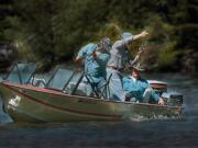 Anglers attempt to bring a spring chinook to the net at the mouth of Wind River.