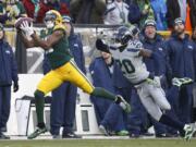 Green Bay Packers' Davante Adams catches a touchdown pass in front of Seattle Seahawks' Jeremy Lane during the first half of an NFL football game Sunday, Dec. 11, 2016, in Green Bay, Wis.