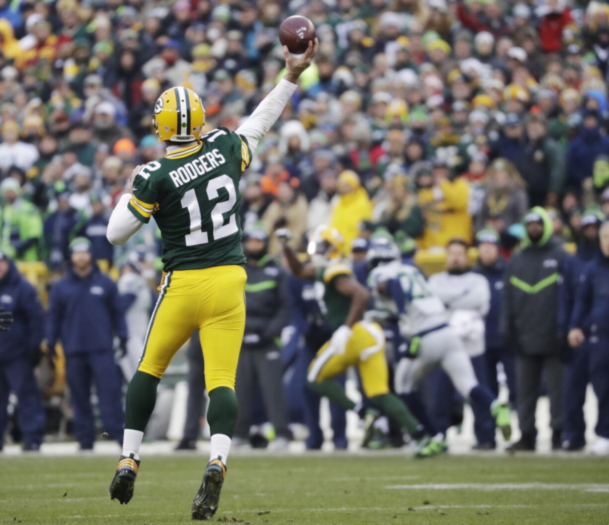 Green Bay Packers&#039; Aaron Rodgers throws a touchdown pass to Davante Adams during the first half of an NFL football game against the Seattle Seahawks Sunday, Dec. 11, 2016, in Green Bay, Wis.