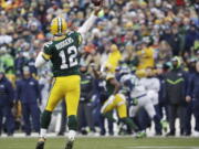 Green Bay Packers&#039; Aaron Rodgers throws a touchdown pass to Davante Adams during the first half of an NFL football game against the Seattle Seahawks Sunday, Dec. 11, 2016, in Green Bay, Wis.