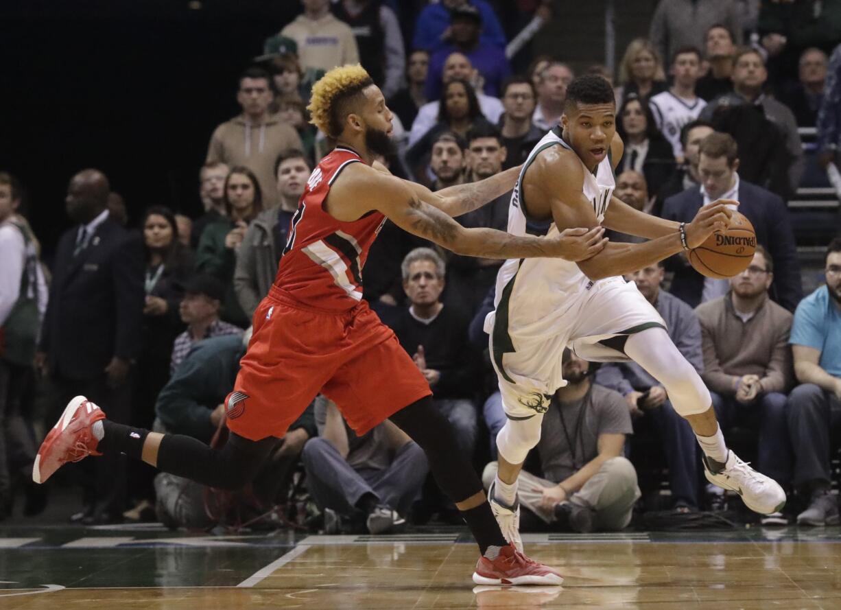 Portland Trail Blazers' Allen Crabbe fouls Milwaukee Bucks' Giannis Antetokounmpo during the second half of an NBA basketball game Wednesday, Dec. 7, 2016, in Milwaukee. The Bucks won 115-107.