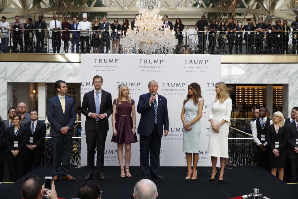 Republican presidential candidate Donald Trump, accompanied by, from left, Donald Trump Jr., Eric Trump, Trump, Melania Trump, Tiffany Trump and Ivanka Trump, speaks during the grand opening of the Trump International Hotel- Old Post Office, in Washington.