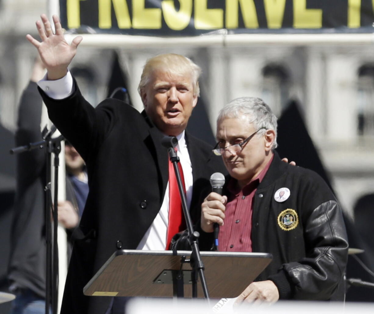 Donald Trump, left, is joined by Carl Paladino during a gun rights rally at the Empire State Plaza in Albany, N.Y. The board of education for the public school system in Buffalo, New York, has called a special meeting in the wake of derogatory statements about President Barack Obama and his wife made by Paladino, who&#039;s a board member and co-chaired the Trump campaign in New York.