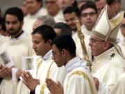 Pope Francis, right, celebrates a Mass to mark the feast of Our Lady of Guadalupe, in St. Peter&#039;s Basilica, at the Vatican on Monday.