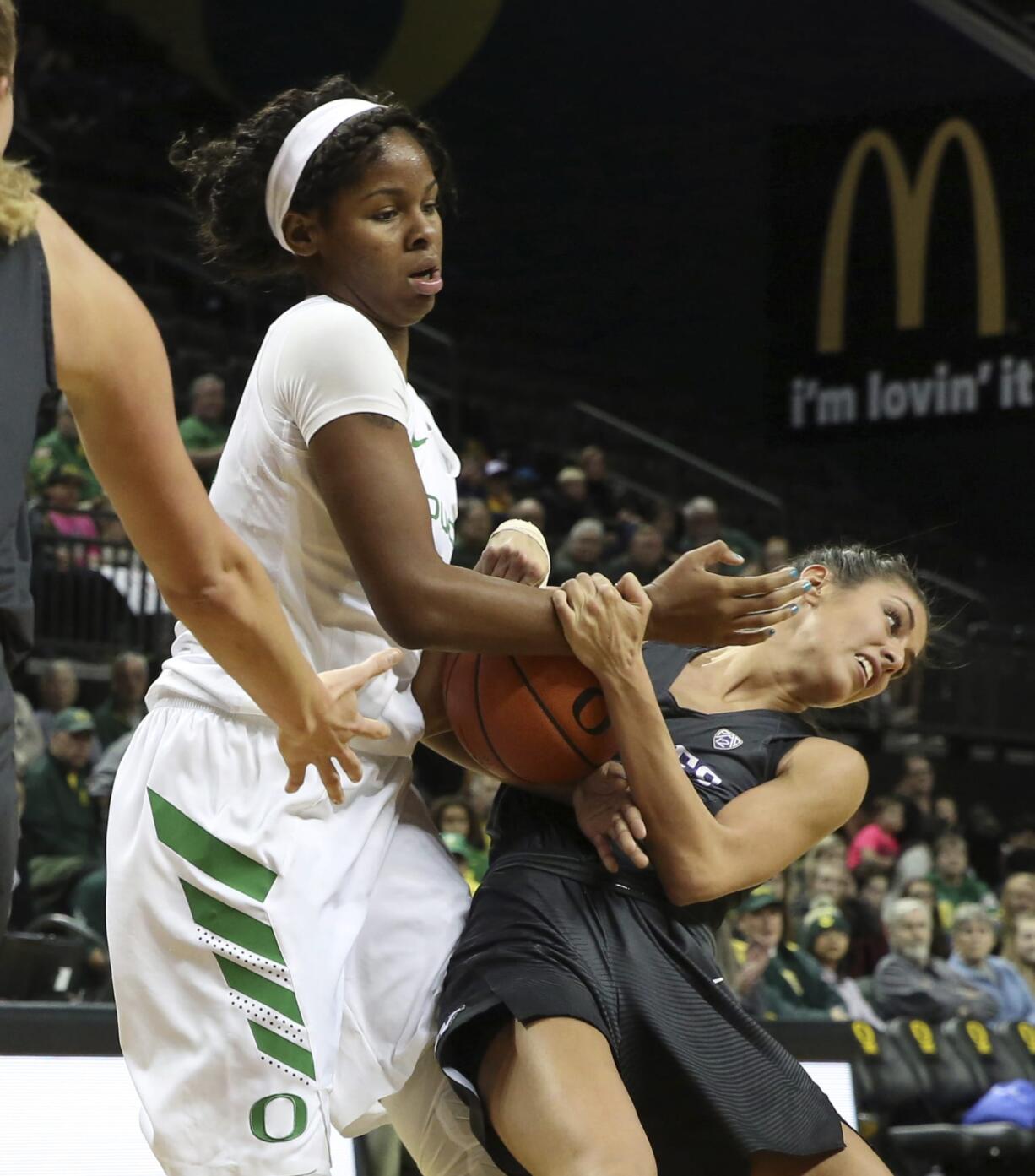 Oregon's Ruthy Hebard, left, fights for possession of the ball against Washington's Heather Corral during an NCAA college basketball game Friday, Dec. 30, 2016, in Eugene, Ore.