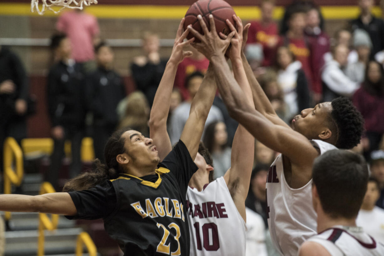 Marcos Cadiz (23) of Hudson&#039;s Bay fights for the ball with Prairie&#039;s Seth Hall (10) and Dwayne Stewart (24) during the first quarter of Prairie&#039;s win.