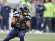 (Seattle Seahawks wide receiver Doug Baldwin gets set to pass to quarterback Russell Wilson for a touchdown against the Philadelphia Eagles in the second half of an NFL football game, Sunday, Nov. 20, 2016, in Seattle.