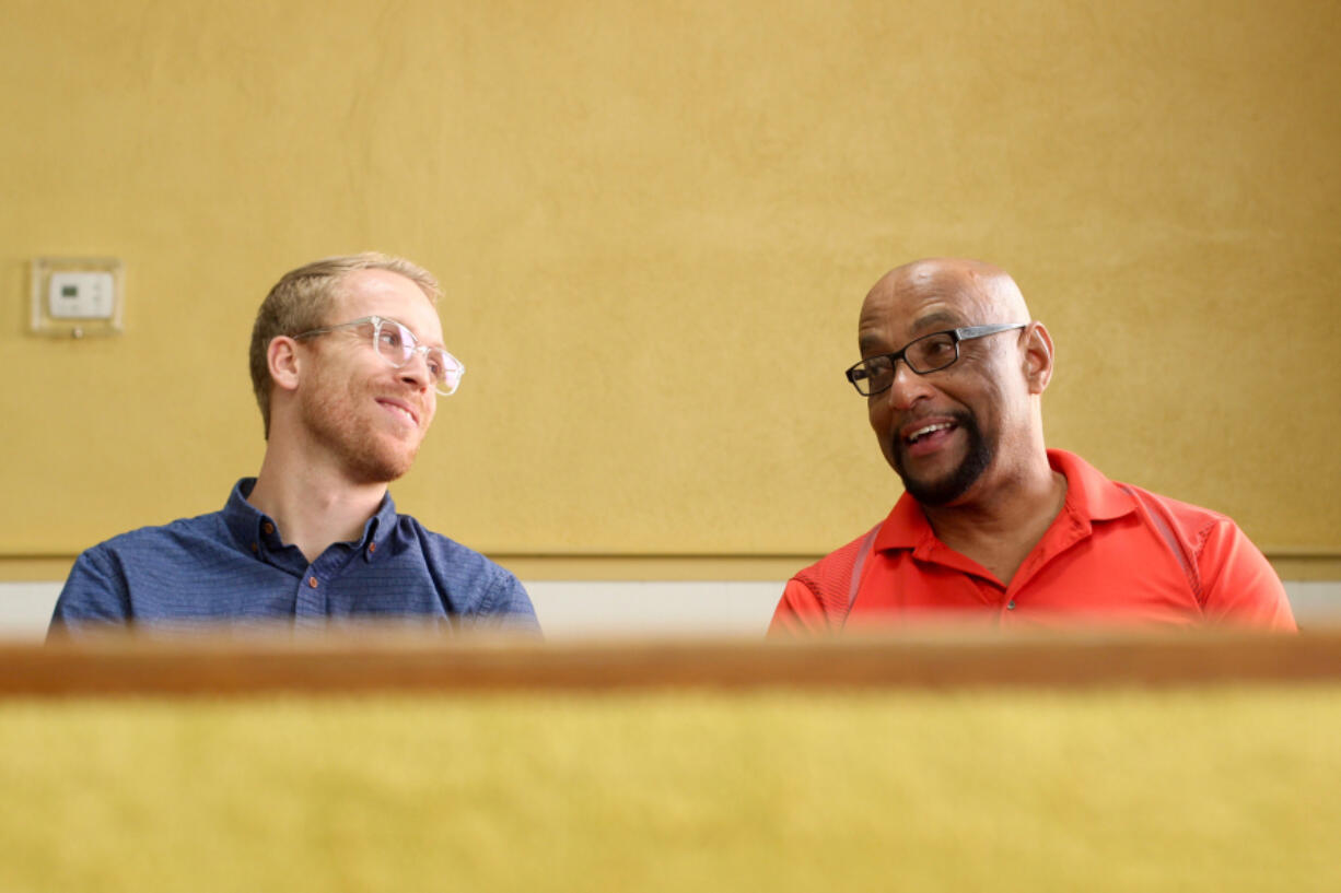 Pastor Kyle Meier, left, of Peak United Methodist Church, chats with Rev. James Taylor in the sanctuary of St. Mary AME Church in Apex, N.C.