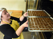 Cynthia Sieling puts trays of dog biscuits in the oven and she and other members of the St. Francis Homeless Project, make the treats at the Institute of Technology, for the Dogs Dig Em&#039; ministry. She&#039;s is a client in the project which employs former homeless women who complete drug/alcohol rehab.