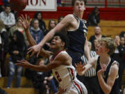 Fort Vancouver&#039;s Johnny Green, left, shoots against Kelso&#039;s Shaw Anderson, center and Reece Tack.