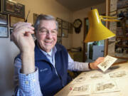 Former Columbian staffer Jim Shinn shows some of his cartoons at his home in Vancouver in 2012.