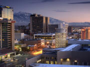 As the sun slips behind the mountains, the nighttime glow of downtown Salt Lake City begins to emerge.