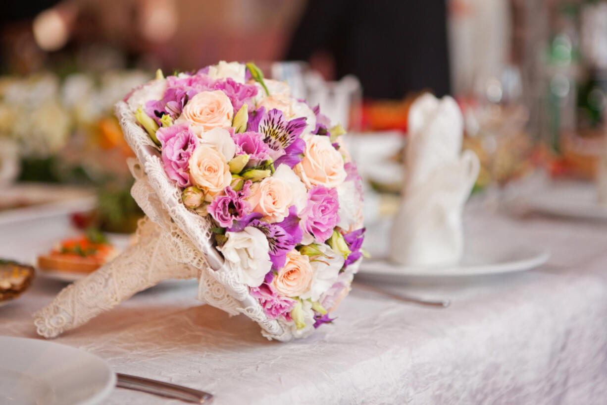 Beautiful wedding boquet lying on table.