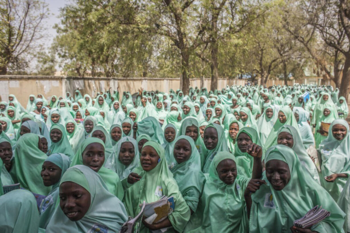 Schoolgirls leave the Women&#039;s Teachers College Secondary School at the end of a school day in Maiduguri, Nigeria. Worldwide, men and women are going to school at about the same rate.