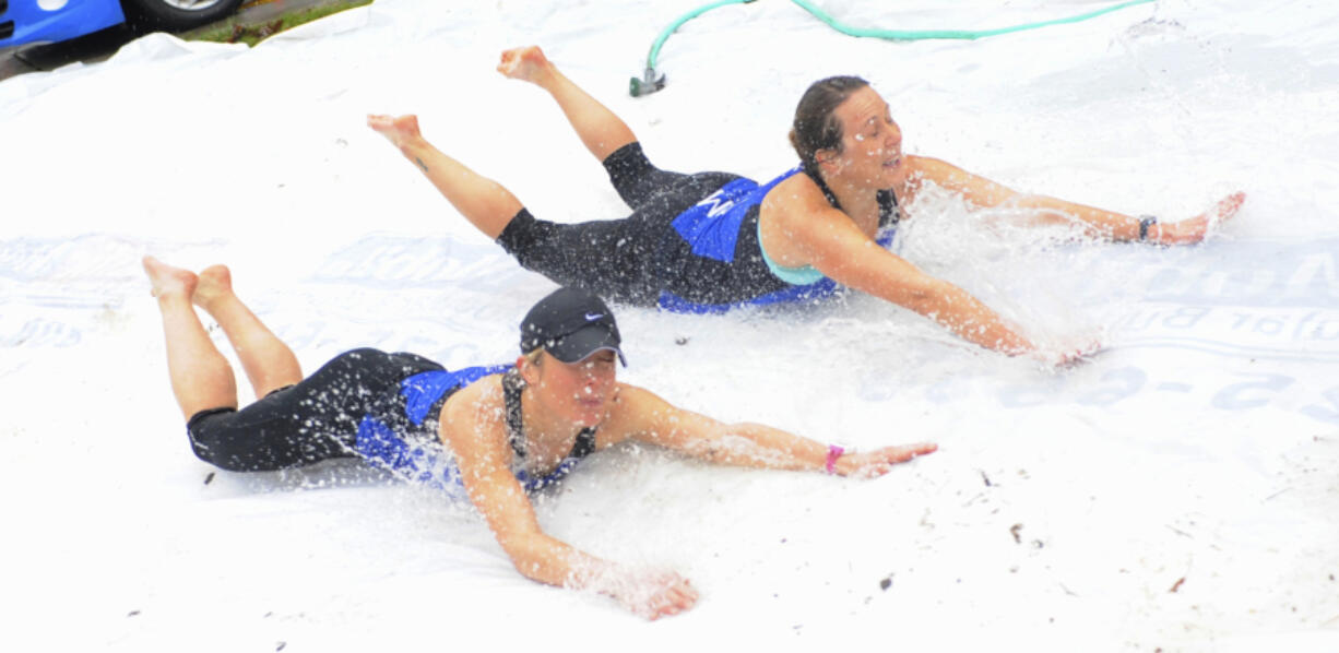 Gail Moebius and Laura Bocho, top, try the Polar Bear Slide at the 2015 Resolution Run in Battle Ground.