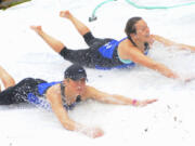 Gail Moebius and Laura Bocho, top, try the Polar Bear Slide at the 2015 Resolution Run in Battle Ground.