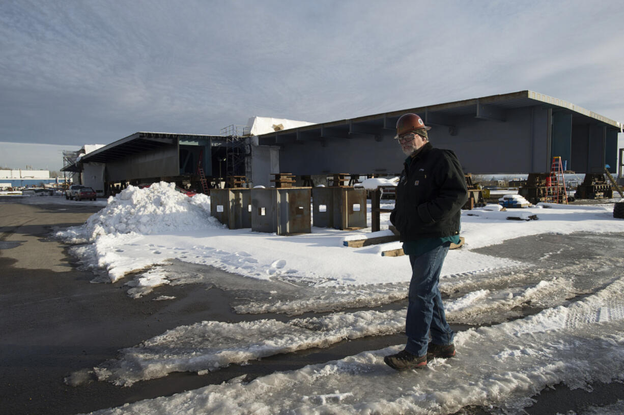 Vigor Industrial plant manager Greg Arnold walks past the Wittpenn Bridge section under construction in mid-January. Arnold is hopeful for more favorable manufacturing in the future, but he will take a wait-and-see approach.