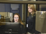 Police records specialist Sara Cox works with records supervisor Gail Truax at the Vancouver Police Department&#039;s West Precinct in the new records office last month.