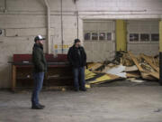 Co-owners Brendan Greenen, left, and Mike Hunsaker look over the former Lemon-Aid Automotive warehouse, which they are in the process of turning into Grains of Wrath.