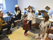 EggDrop leaders Miranda Bickford, from left, and Lauren Edmonds attempt to work in their Vancouver office while Edmonds&#039; daughters, Penny and Mya Edmonds, play with Bickford&#039;s daughter, Evelyn Bickford, far right, during another snow day Tuesday.