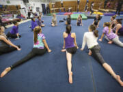 The growing gymnastics team from Columbia River High School practices at Naydenov Gymnastics center in Vancouver.
