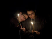 Mourners attend a vigil Saturday in Vancouver for Amy Hooser, 47, who was killed last Sunday.