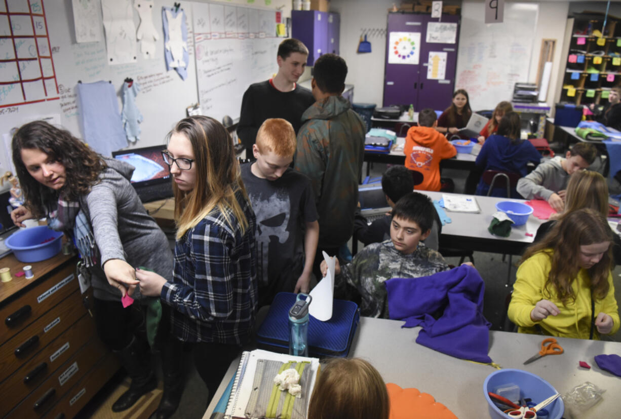 Art teacher Michelle Hankins points to art supplies from a crammed corner of her classroom at View Ridge Middle School. The Ridgefield School District will run a bond vote on Feb. 14 to help alleviate overcrowding in schools, partly by moving students out of Ridgefield onto a new campus across from the high school.