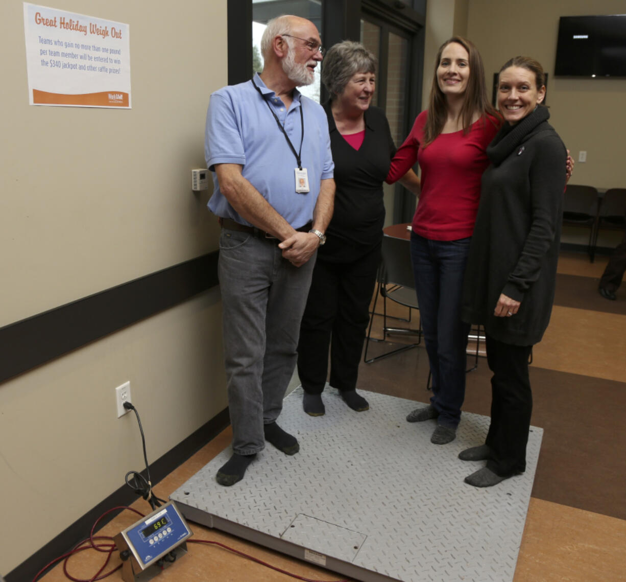 Vancouver Public Works team &quot;The Sustainables,&quot; Rich McConaghy, from left, Linda Jones, Julie Gilbertson and Tanya Gray, stand on a scale for the &quot;Great Holiday Weigh Out.&quot; The event challenged teams of employees to maintain their weight through the holidays. It was one of the more popular events offered through the city of Vancouver&#039;s new employee wellness program.