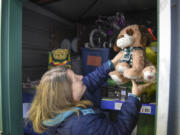 Vicki Fitzsimmons, co-chair for the Holiday Youth Giving Event, organizes toys in a storage unit at Salmon Creek Mini Storage in Vancouver. The storage unit, filled to the ceiling with children&#039;s gifts donated by the community, will be distributed to children in need at the Holiday Youth Giving Event on Thursday.