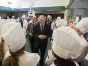 Gov. Jay Inslee, center, chats with culinary students during a &quot;Mini Inaugural Ball&quot; at Cascadia Technical Academy on Tuesday. The program&#039;s culinary students normally cater the Inaugural Ball but were unable to this year due to snow.