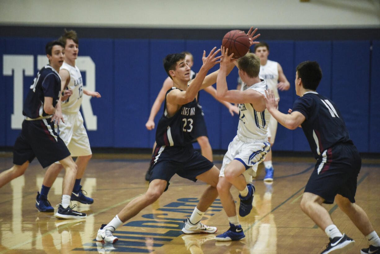 King's Way Christian's Matt Garrison (23) blocks La Center's Avery Seter (12) during the second quarter at La Center High School, Tuesday January 24, 2017.