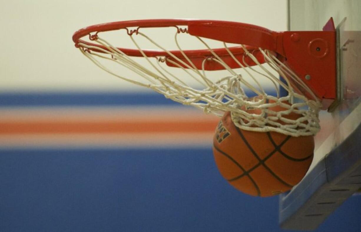 The basketball rips the net at Ridgefield High School.