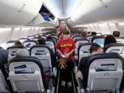 A Vancouver family boards a plane during an event hosted by the Autism Society of Oregon and Alaska Airlines to help those with autism adjust to flying.